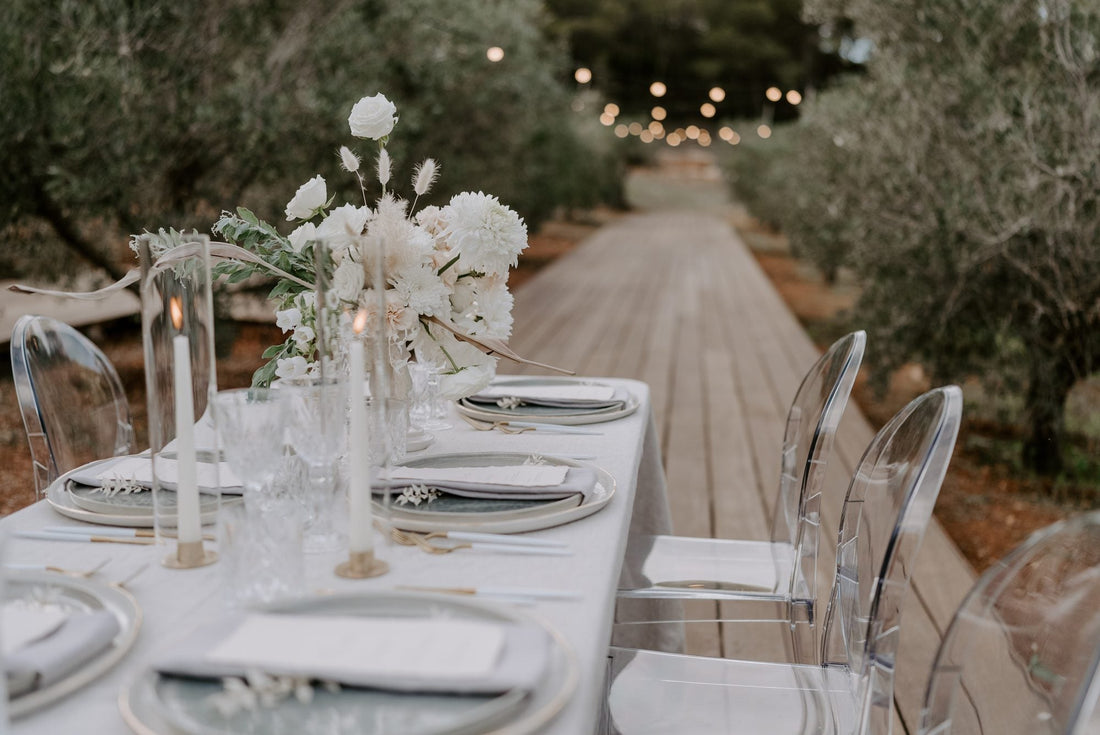 Event table with clear glass vase centerpieces and taper candles